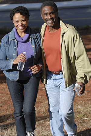 Man and woman outdoors walking.